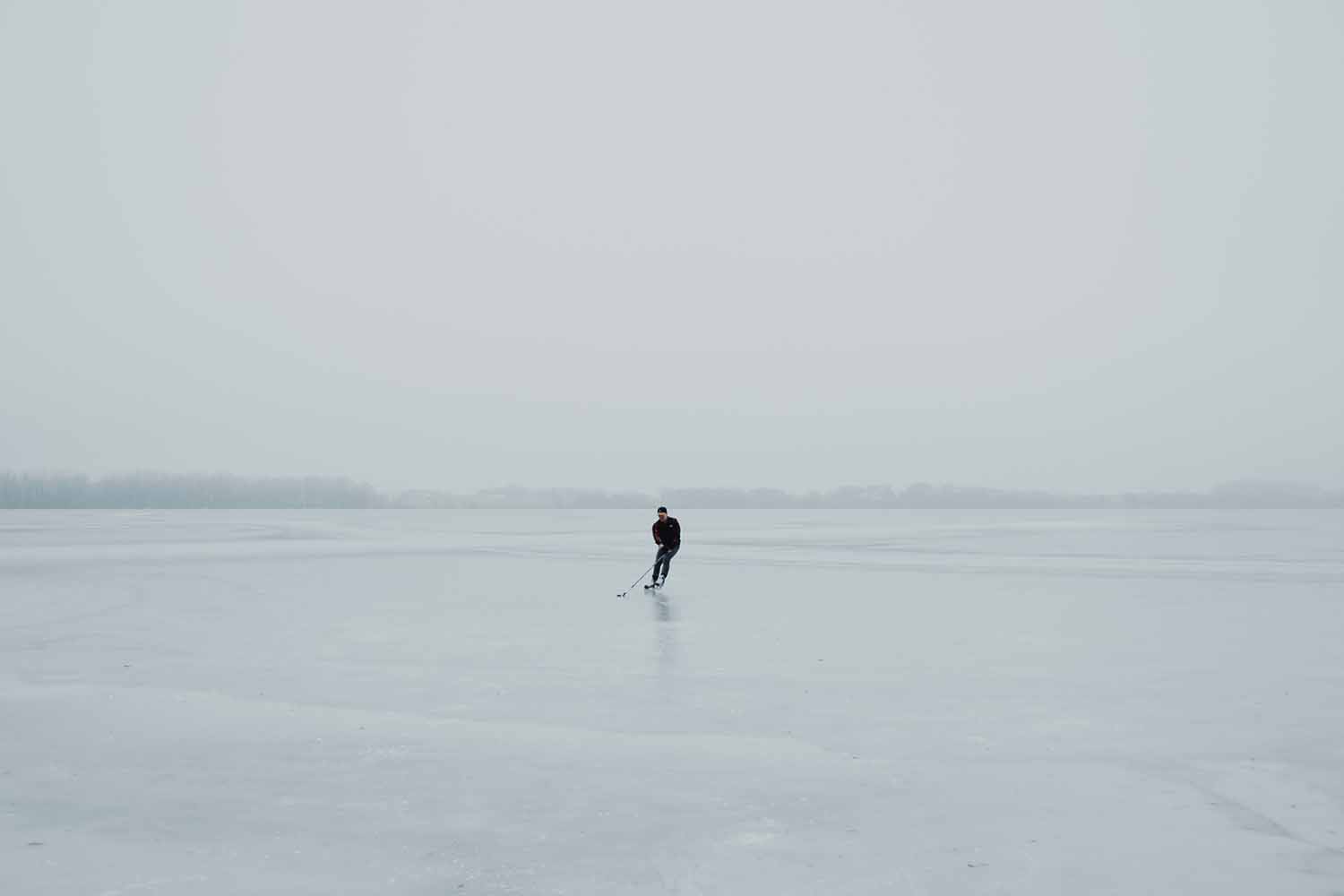 a person skating on a frozen lake